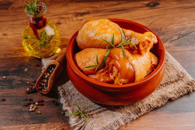 Baharatlı bir tabakta marine edilmiş tavuk budu.