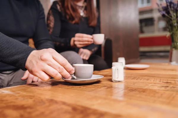 A girl and a man in a cafe drink coffee with milk. Coffee house.