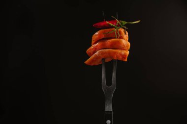 Çiğ salamura edilmiş tavuk filetosu, parçalara bölünmüş et, uzayı kopyala. Çiğ marine edilmiş tavuk filetosu, siyah arka planda bir çatalla ikiye bölünmüş..