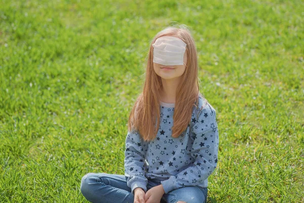 Little girl plays in nature with a mask from viruses on her face. Coronavirus and children. Sad child. Masks from coronavirus.