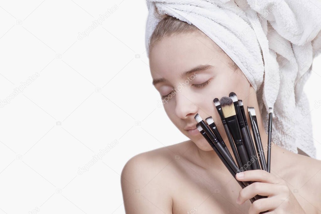 Girl with cosmetic brushes. Face care. Cosmetic procedures.Cosmetology, visage, wellness concept