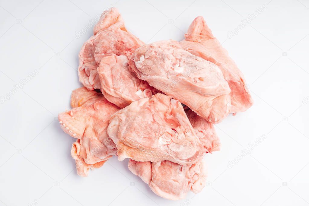Chicken bones for soup. Product for retail.Raw chicken meat. Chicken offal, bones, backs on a white background. chicken meat sliced as food background