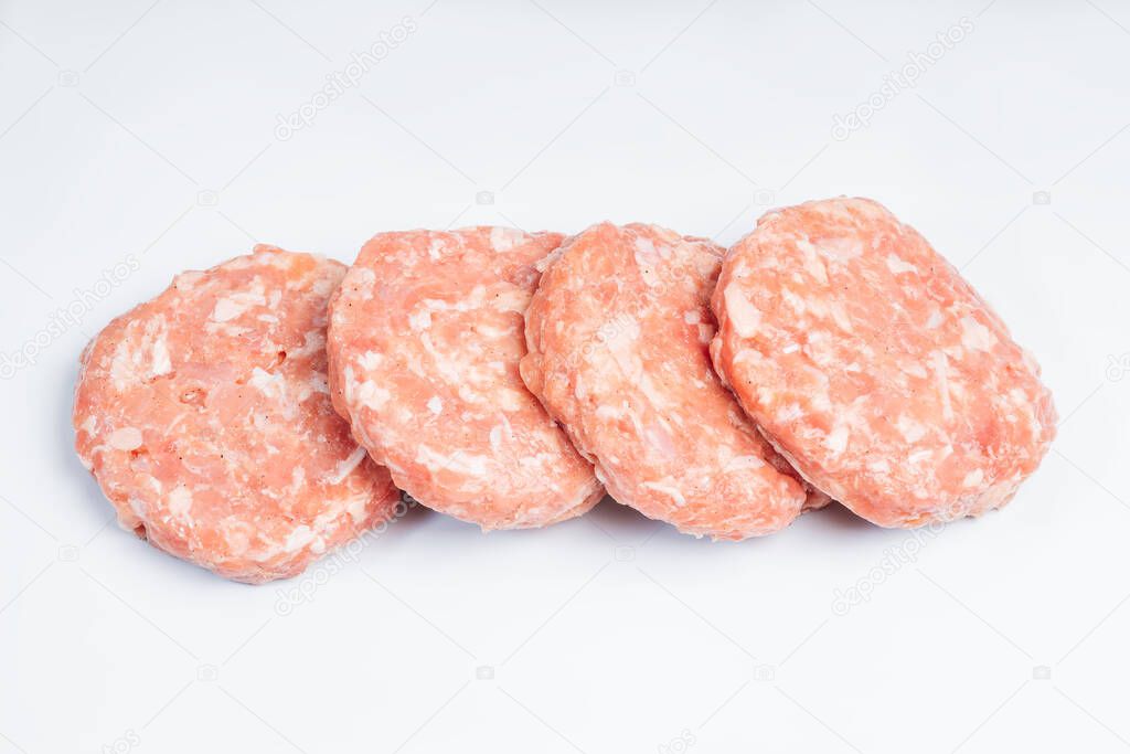 Four pieces of chicken burgers on a white plate. Fast food for home and restaurants. Semi-finished product, chicken meat fast cooking. Copy space.