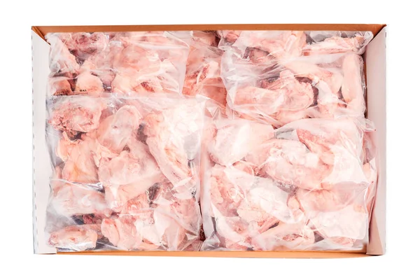 Raw chicken backs in a package packed in a box for delivery on a white isolated background, top view. Raw meat box for supermarket, retail.
