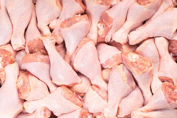 Fresh chicken leg with skin many pieces close-up for a supermarket, retail. Raw chicken meat.Raw chicken legs .