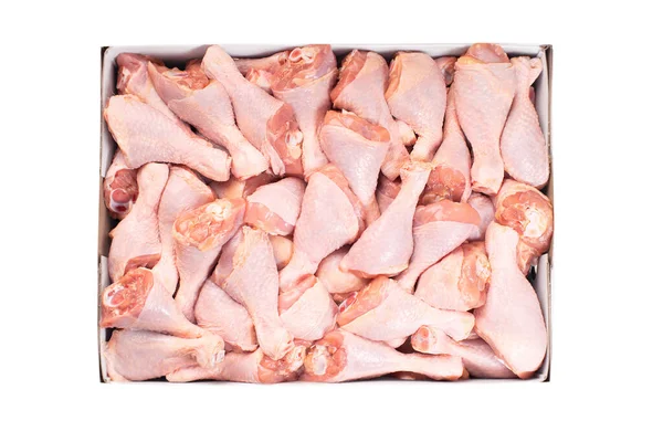 Fresh chicken leg with skin many pieces close-up in a cardboard box for a supermarket, retail. Raw chicken meat.Raw chicken legs on white background isolated