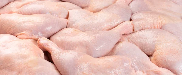 Fresh chicken leg with skin many pieces close-up for a supermarket, retail. Raw chicken meat.Raw chicken legs .