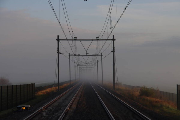 Fog over railroad track at the lowest polder in the Netherlands Zuidplaspolder between Gouda and Rotterdam 