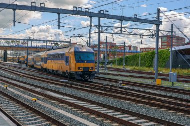 DDAZ çifte güverte banliyö treni Hollanda 'daki Zwolle İstasyonu' na gidiyor.
