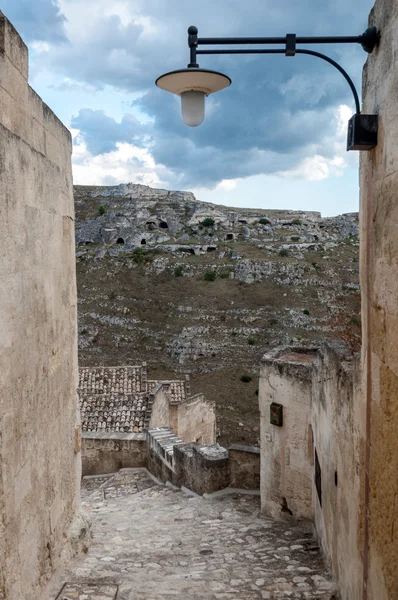 Passagem com lanterna que leva à vista de cavernas antigas de Sassi — Fotografia de Stock