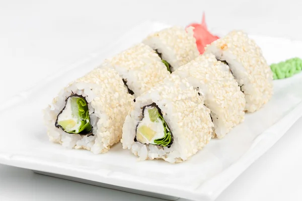 Three-cornered sushi roll with fish, cucumber and green salad. — Stock Photo, Image