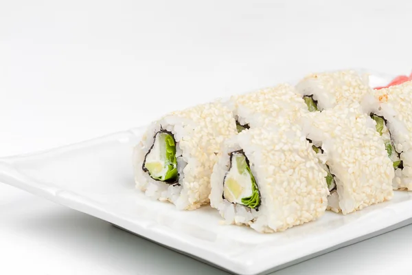 Three-cornered sushi roll with fish, cucumber and green salad. — Stock Photo, Image