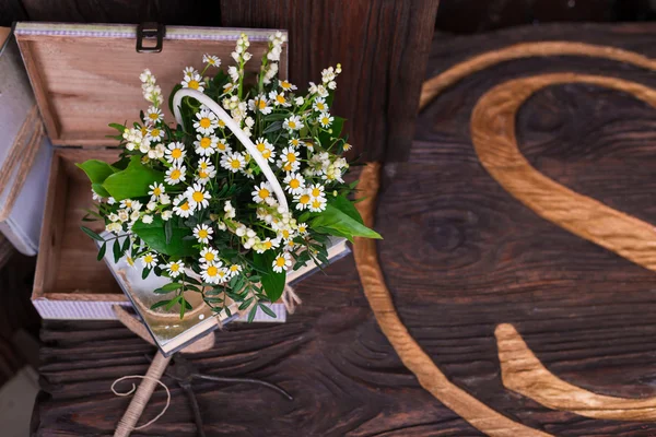 Kamille decor compositie bij boeken en vak op de bruin houten tafel — Stockfoto