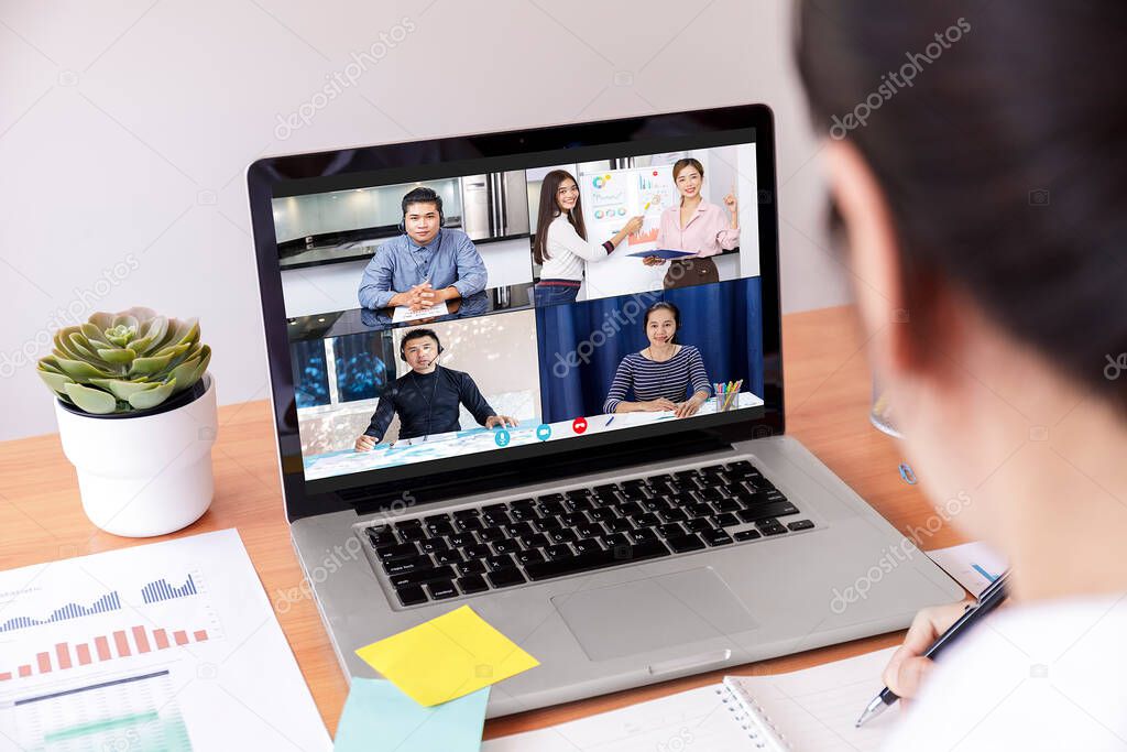 Businessman and businesswoman analysis financial chart with videoconference online meeting. Hand of businesswomen using laptop meeting with diverse colleagues. Covid-19 working from home. With copy space banner
