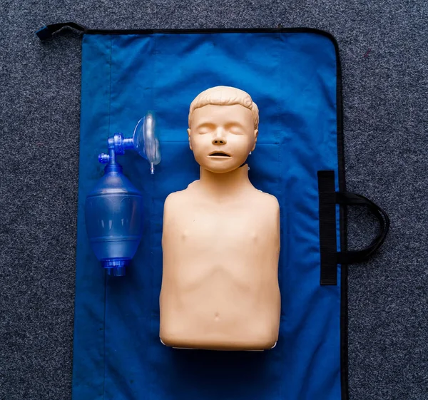 First medical help training equipment. Medical dummy and oxigen mask. Close up.