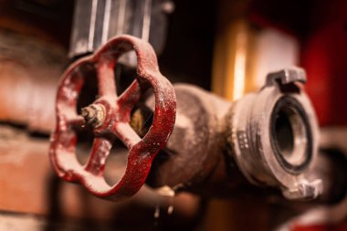 Ana boru hattında su kaynağı var. Kırmızı tuğlalar duvar arkası. Yakın çekim..