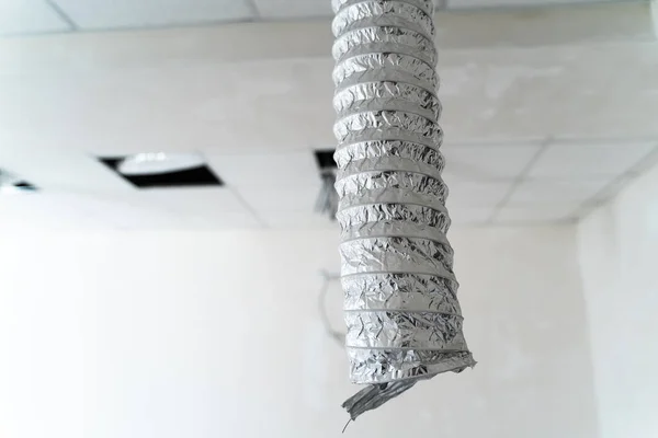Air ventilating tube in building hanging from the ceiling. Aluminium air conditioning tube.