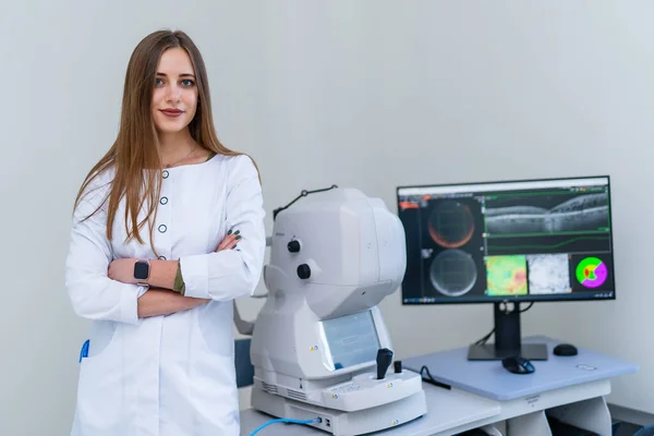 Female radiologist stands near monitor with teating results. Modern equipment in up to date clinic.