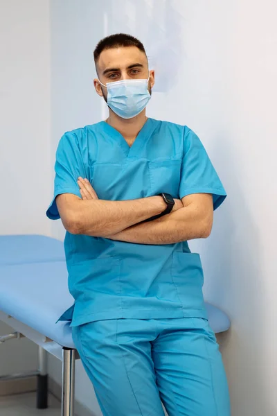 Portrait of a senior male doctor sitting at doctor\'s office and looking at side. Thoughtful face of experienced doctor.