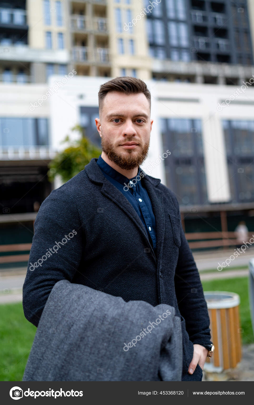 Cute Man Looks Camera While Wearing Formal Suit Holding Gray — Stock Photo  © wedmov #453368120, image size:1067x1700