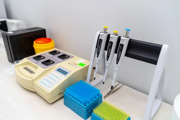 Blood test in the laboratory. Laboratory work with dispensers. Vacuum tubes for blood. Closeup.