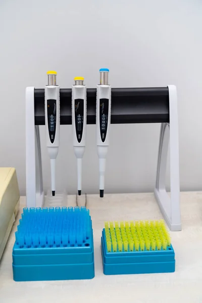 Special equipment for blood testing. Empty blood tubes in a raw. Three pens for blood testing. Closeup.