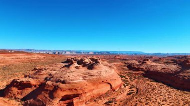 Incredible rounded rocks in the hot barren desert. Arid landscape of Arizona bordering with Utah. Aerial view.