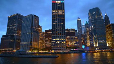 Boat trip along the pier in New York, USA. Low angle view on the high-rises of Manhattan in the evening.
