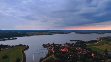 Lakeside marina at dusk. A quiet German marina with calm lake waters during dusk light.