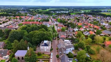 Panoramic view of Dutch suburb. An aerial look at a suburban Dutch settlement surrounded by expansive fields.