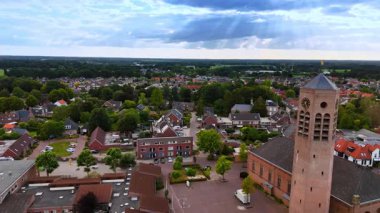 Sunlit village with central tower. A drone view shows the center of a small Dutch town with a tower on the main square.
