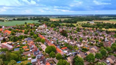 Green districts of low-rise housing. Low-rise Dutch residential areas immersed in dense green vegetation.