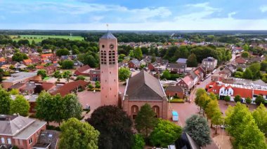 Dutch village beside open farmland. A panorama of a Dutch village blending rooftops with open agricultural fields.