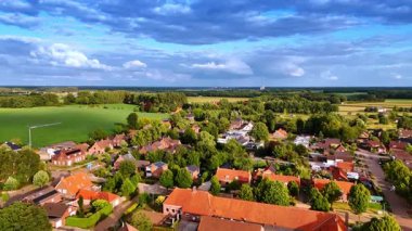 Town homes by open landscapes. Low-rise Dutch housing positioned near vast open countryside landscapes.