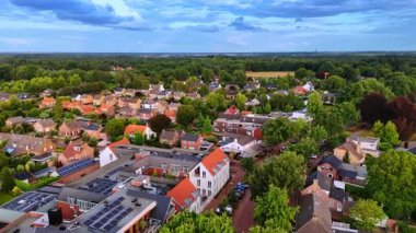Residential Dutch neighborhood from above. High-angle view of residential Dutch streets lined with gardens and rooftops.