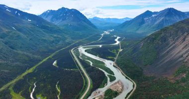 Valley river winding through Alaska. Scenic Alaskan valley with a winding river between rugged green mountains