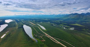 Wide Alaskan plains with lakes. Expansive Alaskan plains with winding lakes and distant snowy mountain peaks
