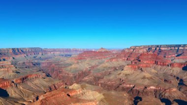 Red rock layers across canyon. Layered red rock formations create a dramatic canyon scene.