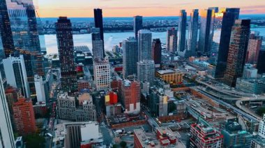 New York, ABD, 8 Ağustos 2025: Günün sonunda New York 'ta işe gidip gelmek. Hava manzarasından alacakaranlıkta canlı bir şehir. Arkaplanda nehir manzarası.