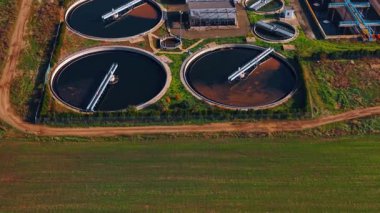 Big and small round water tanks for sewage recycling. Aerial perspective on the territory of modern sewage treatment plant.