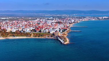 Cityscape of the sunny city in Bulgaria at the sea coast. Drone footage over the blue waterscape of the Black Sea.