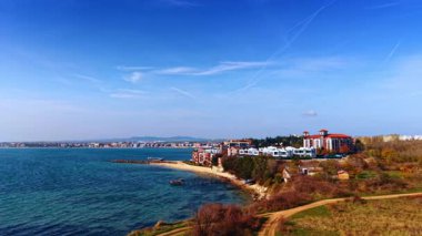 Beautiful modern houses and villas located on the coast of the Black Sea. Drone flight over the blue waterscape on sunny day.
