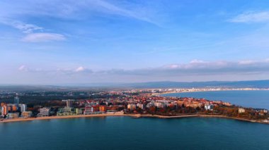 Flight along the coast of the Black Sea. Scenery of Nessebar, Bulgaria from drone. Long cloudscape spread over the mountain range at backdrop.