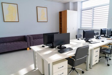 Medical team workstation room. Medical team workstation room arranged with desks and technology for staff tasks.