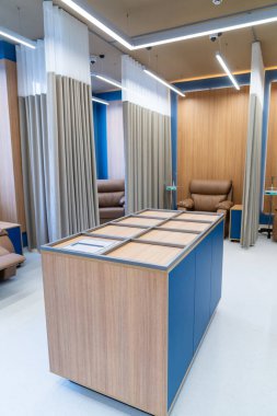 Chemotherapy infusion room with chairs. Modern oncology infusion space with comfortable chemo chairs and privacy curtains.