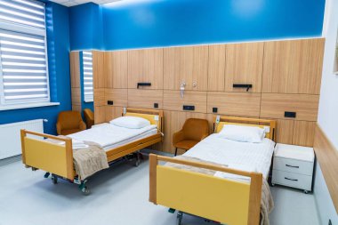 Light medical room with decor. Light medical room decorated in blue with simple furnishings.