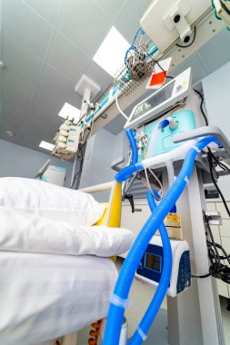 Ventilator tubes and ICU control module. Detailed medical ventilator tubes and control panel in intensive care room.