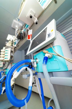 Close view of ICU infusion pump system. Infusion pump modules mounted on intensive care rig inside modern hospital room.