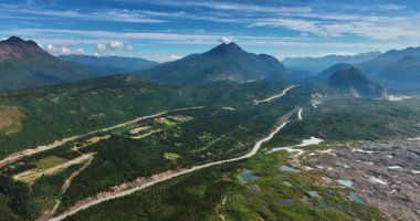Rocky landscape of Alaska with some marshy parts. Gorgeous verdant mountains from drone footage. Aerial view.