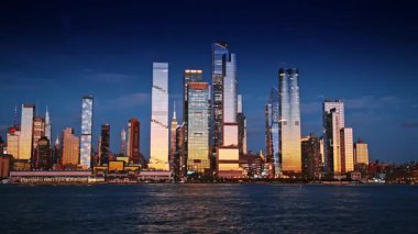 New York, USA, 28 August 2025: Stunning modern architecture of New York with glass facades reflect beautiful light of sunset. Gorgeous skyline from the riverscape. Low angle view.